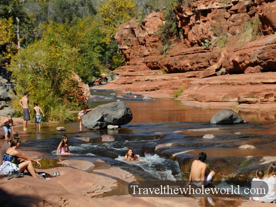 People swimming and sliding through Slide Rock near Sedona, Arizona