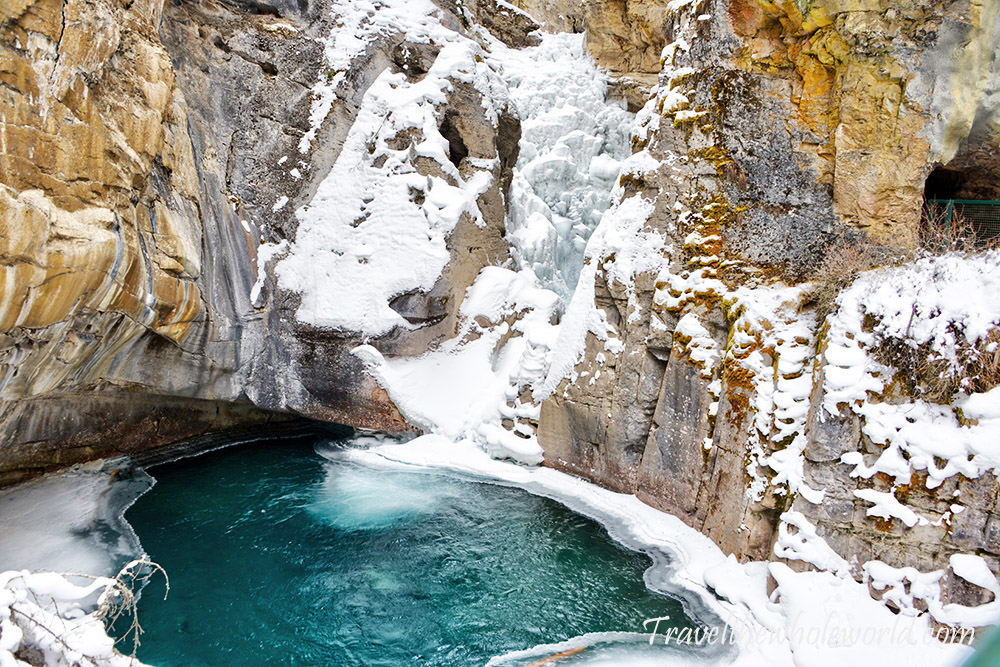 Waterfall and colorful pool in Johnston Canyon Banff