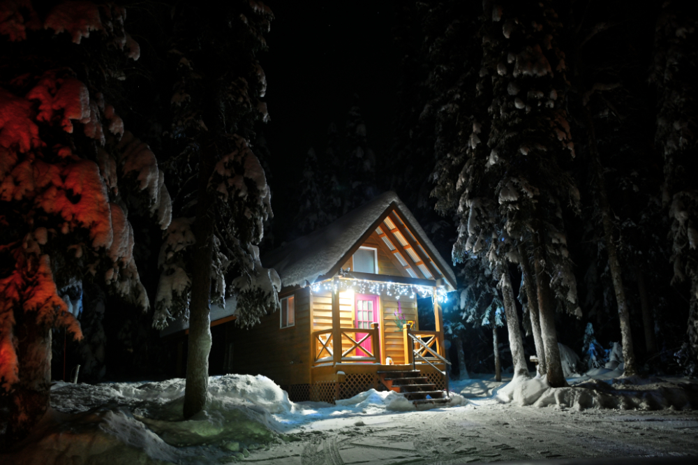 Snow-covered cabin near Fairbanks, Alaska at night