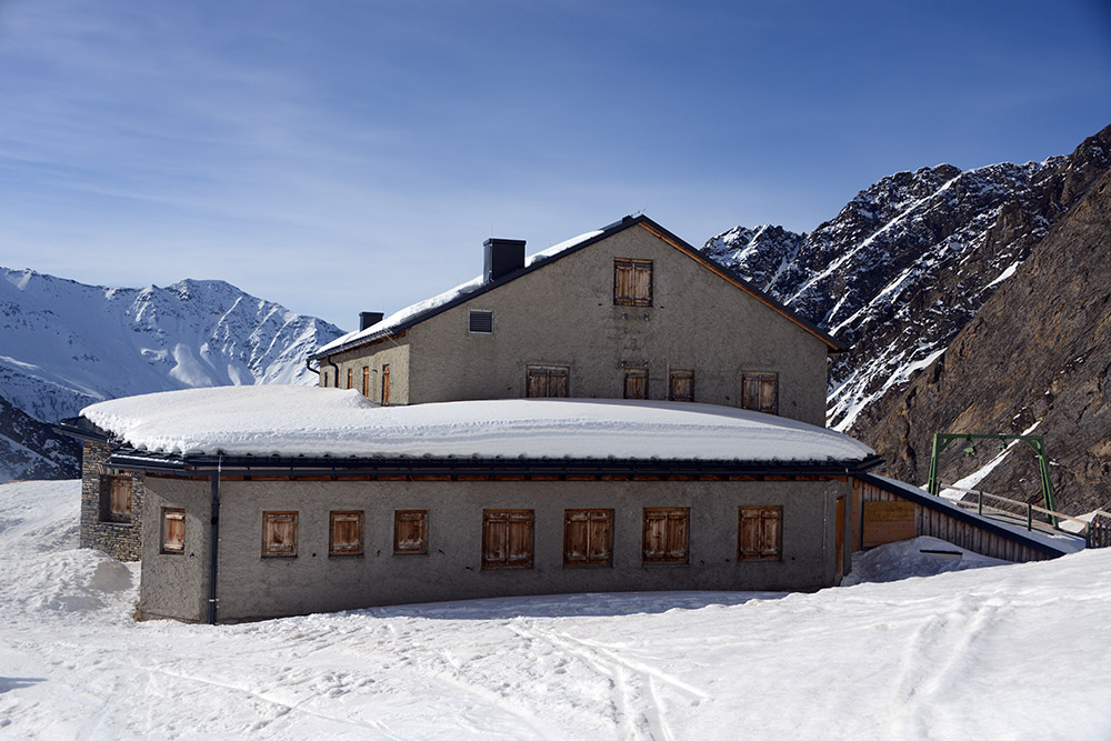 Closed mountain hut surrounded by snow on the Grossglockner route