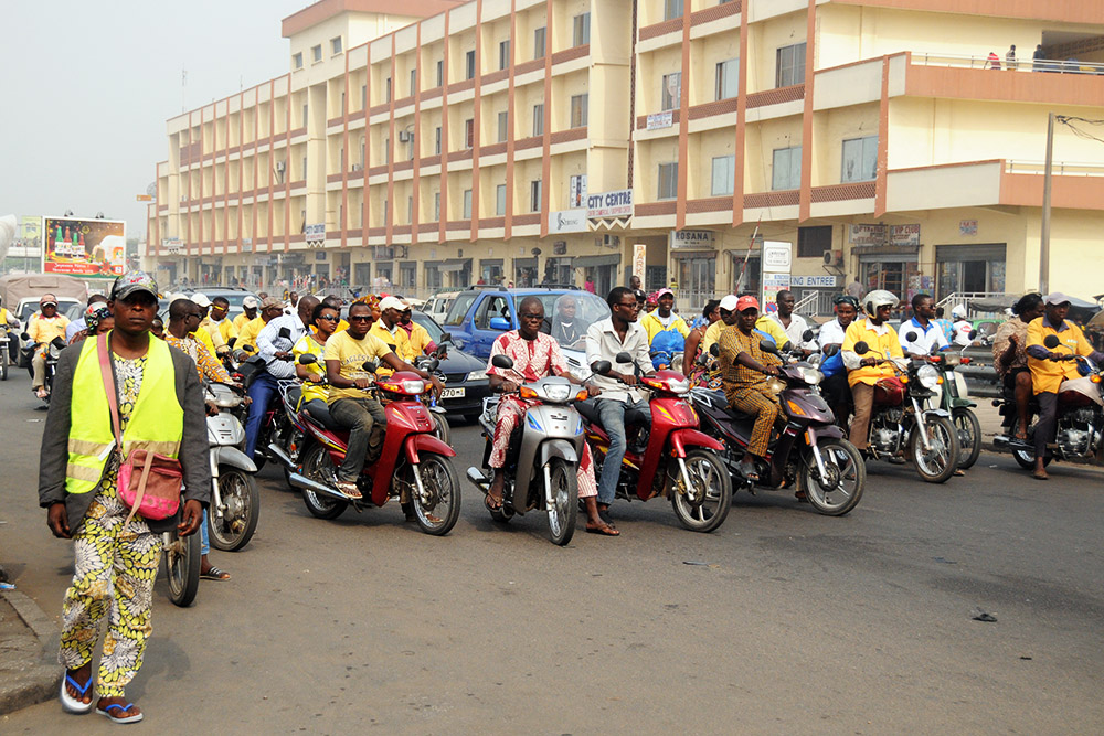 Busy Cotonou road crowded with motorcycles and cars