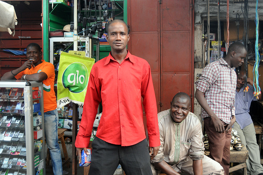 Men talking at a market in Cotonou, Benin