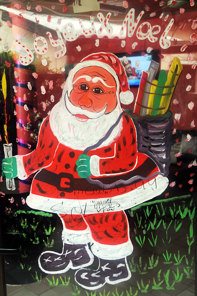 Santa Claus decoration outside a restaurant in tropical Cotonou, Benin