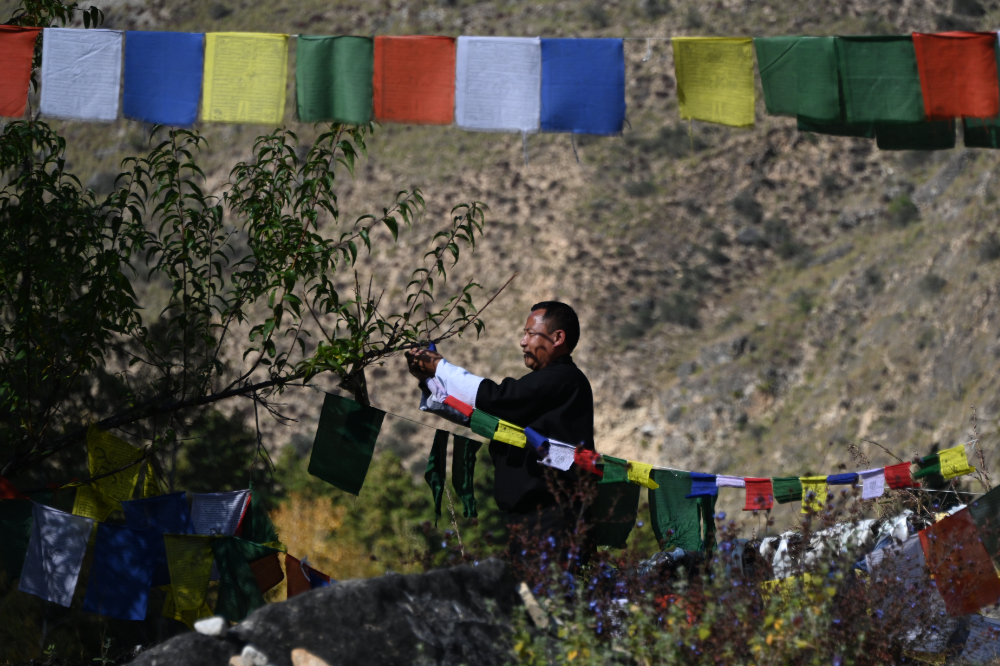 Hundreds of Buddhist prayer flags hanging from a bridge in Bhutan