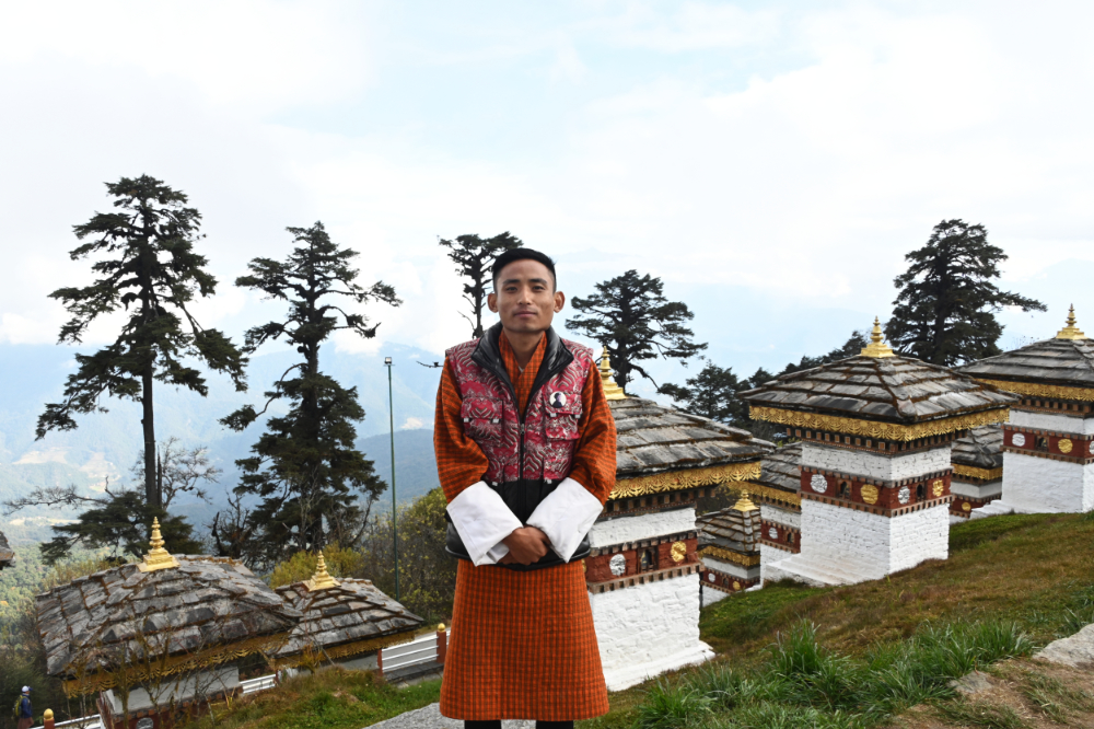 Bhutanese guide looking toward the Himalayan mountains of Bhutan