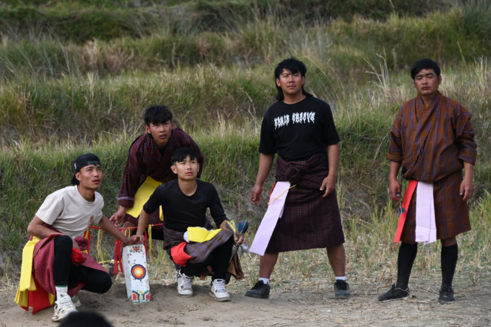 Bhutanese men playing the traditional dart game khuru in Punakha