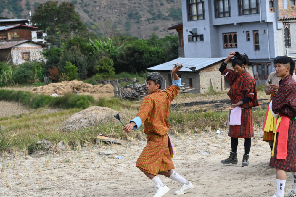 Traditional khuru dart game being played by locals in Punakha, Bhutan