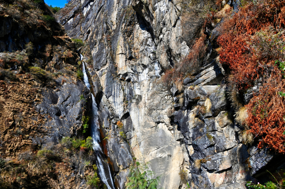 Waterfall plunging through the gorge beside Tiger's Nest Monastery in Bhutan