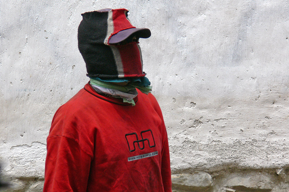 Masked shoe shiner in La Paz, Bolivia