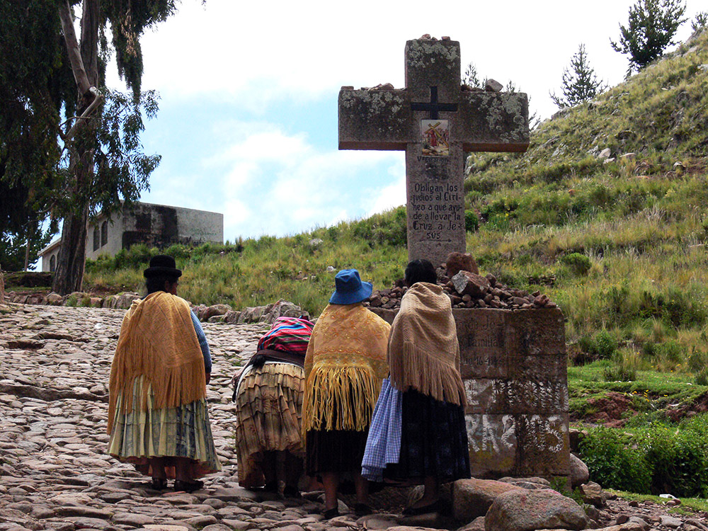 People visiting a Christian cross in Copacabana, Bolivia