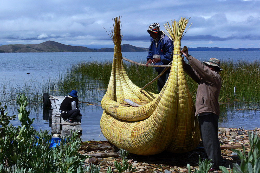 Traditional reed boat being launched into Lake Titicaca