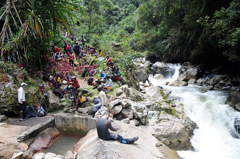 Expedition taking a lunch break in the rainforest on the approach to Carstensz Pyramid