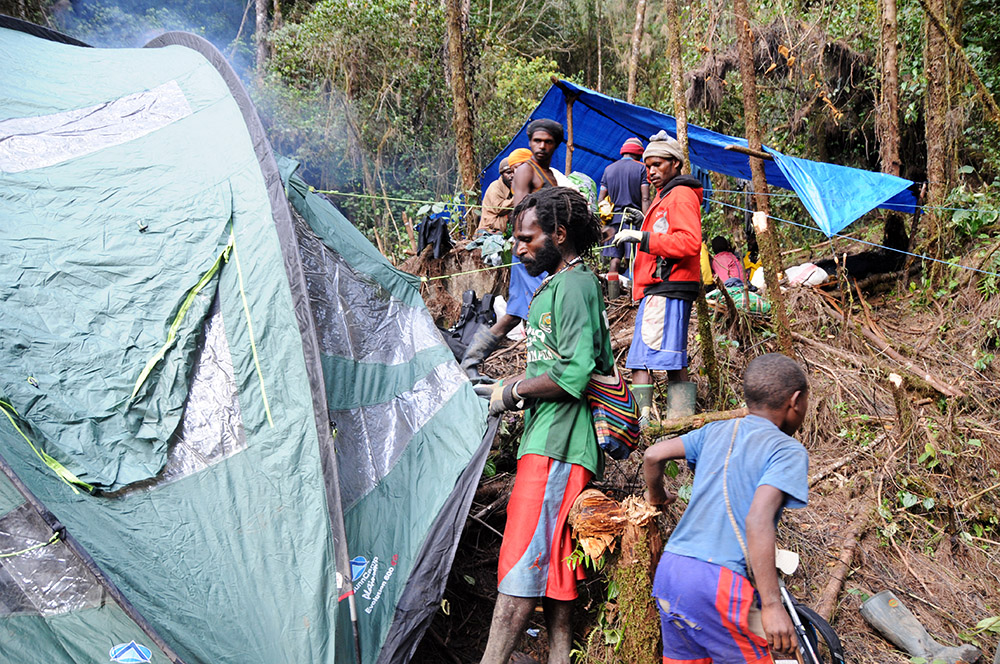Porters setting up Camp I in the rainforest
