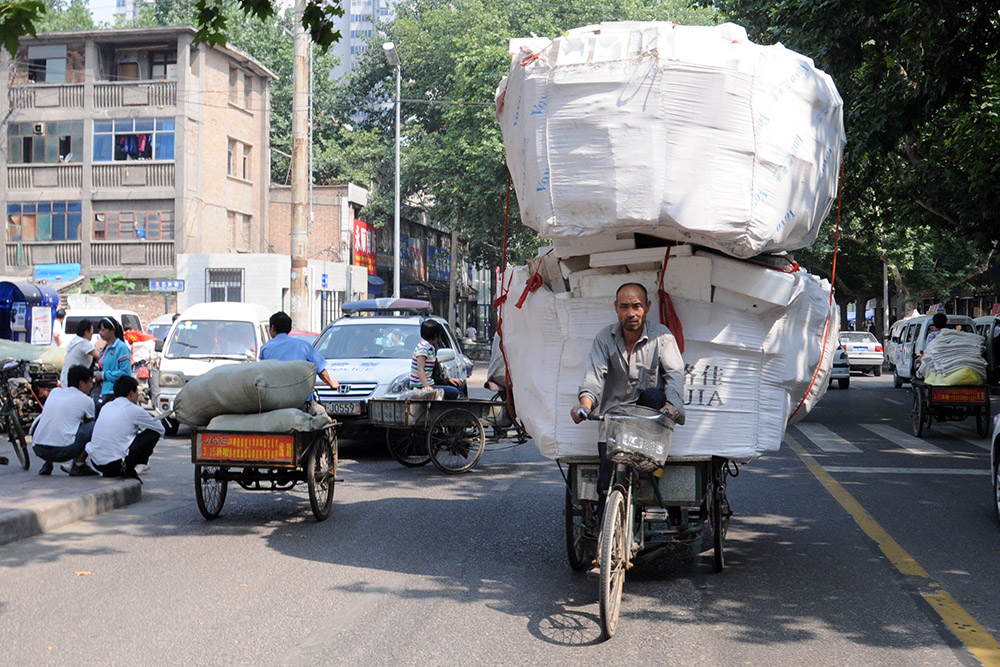 Man carrying a large load on a bicycle in Xi'an