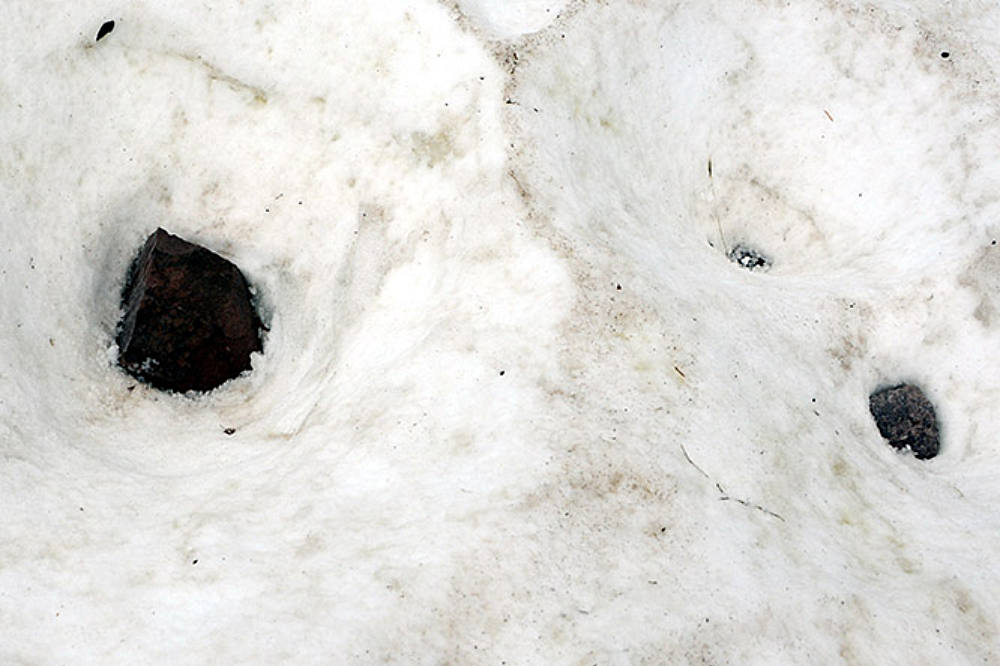 Large fallen rock in the snow on Pyramid Peak