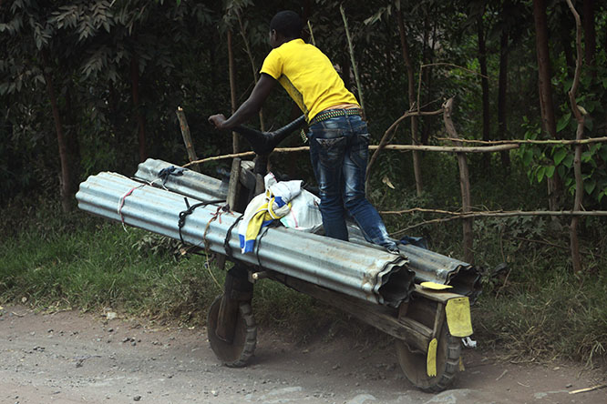 Chukudu Man riding a wooden chukudu in Goma