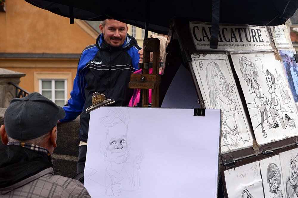Caricature artist near Charles Bridge in Prague