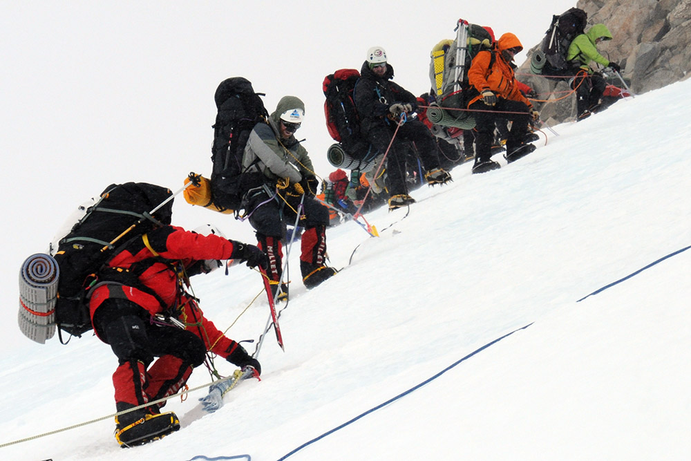Climber being assisted while descending Denali