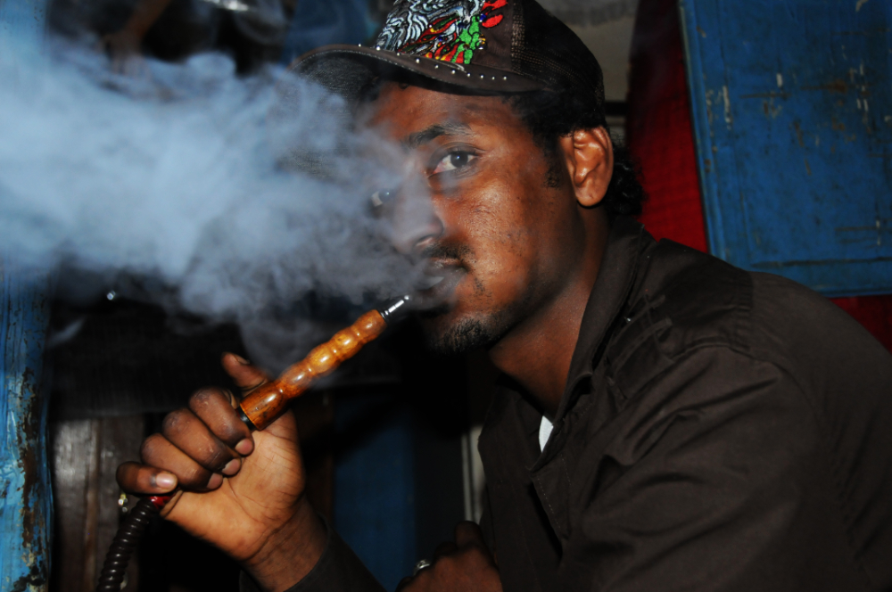 Man smoking shisha in an Addis Ababa lounge