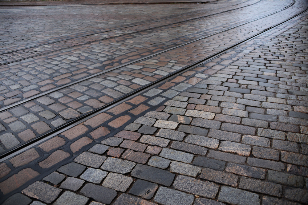 Cobblestone pedestrian street lined with shops in Helsinki, Finland