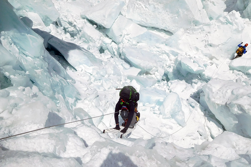 Descending a ladder in the Khumbu Icefall
