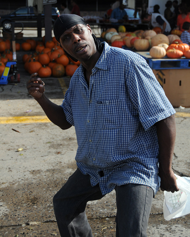 Man posing for a photograph at Eastern Market in Detroit