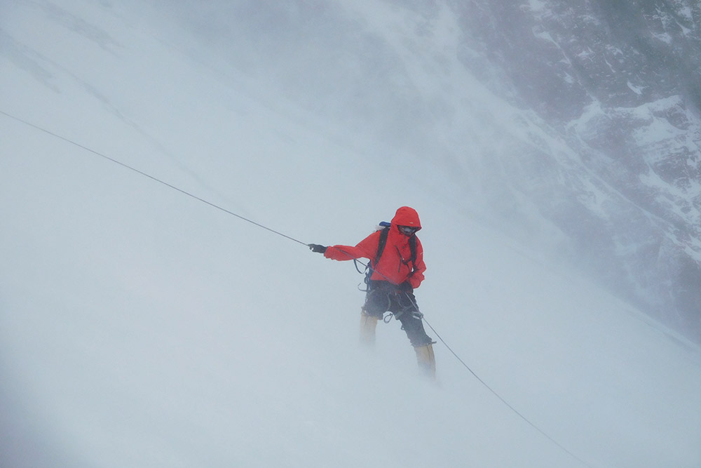 Climber descending the North Col in strong winds