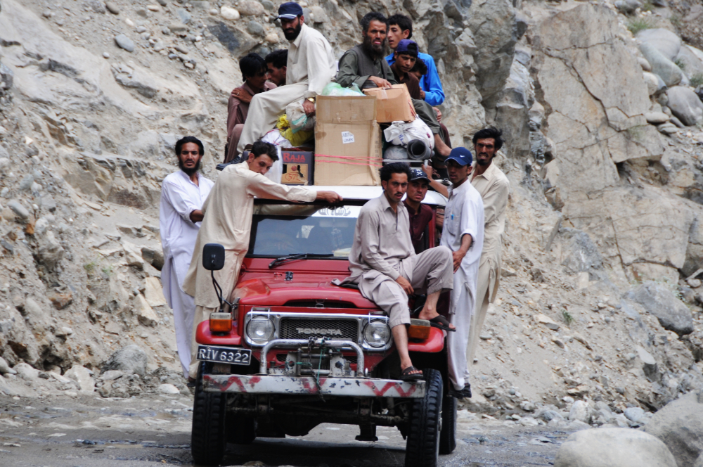 Road Trip Packed jeep on the road through northern Pakistan