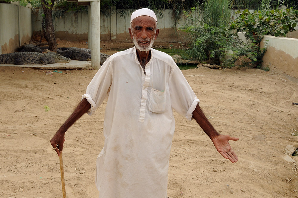 Crocodile caretaker at Manghopir in Karachi, Pakistan