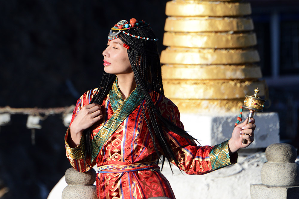 Woman in traditional clothing near Potala Palace