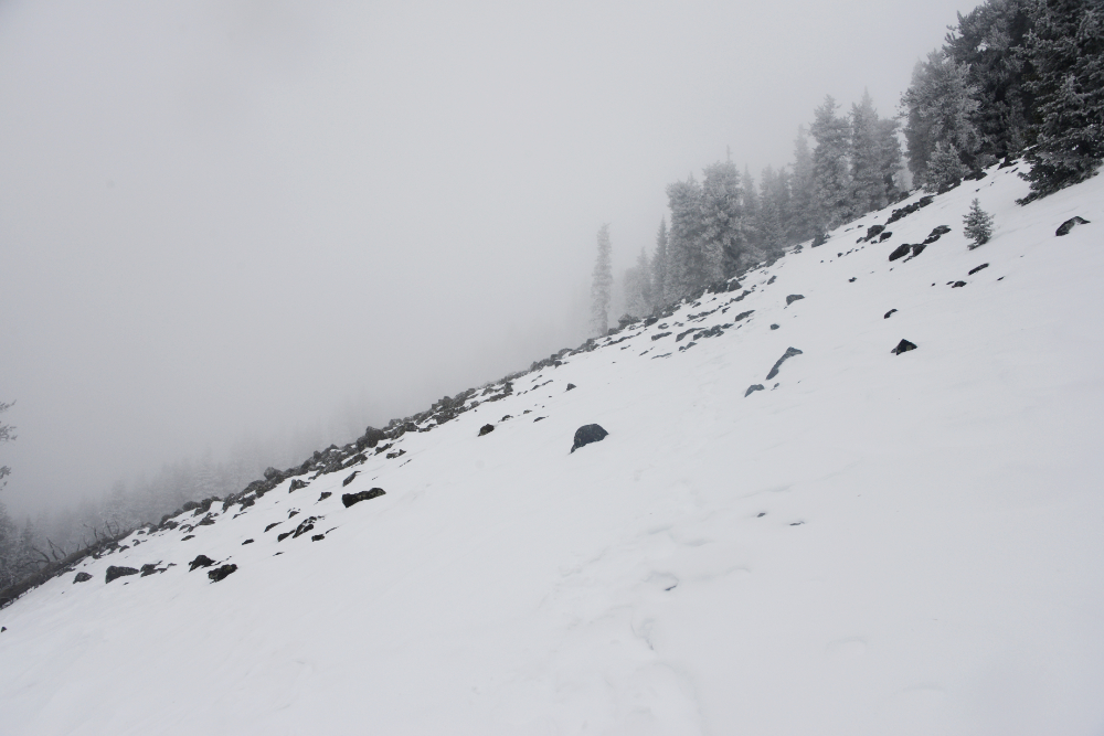 Snow and exposed rock below the summit ridge of Humphreys Peak in winter