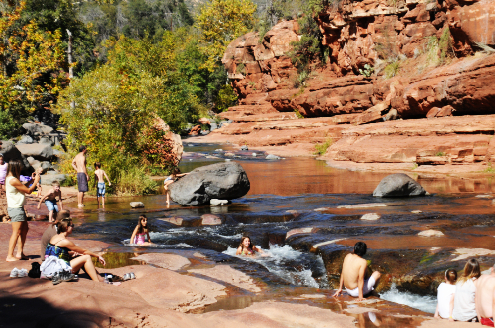 People swimming and sliding through Slide Rock near Sedona, Arizona