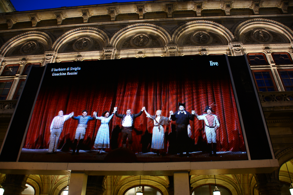 Outdoor screen showing an opera performance in Vienna