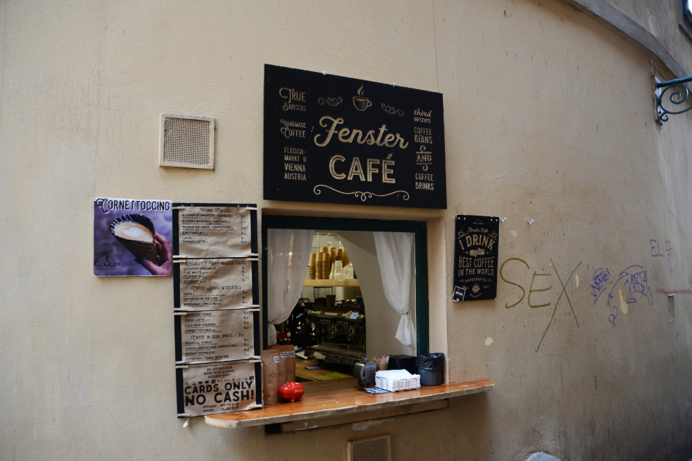 Outdoor cafe seating beside a wall in Vienna