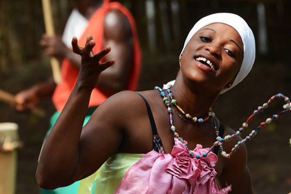 Traditional dancer performing with drummers in Bujumbura