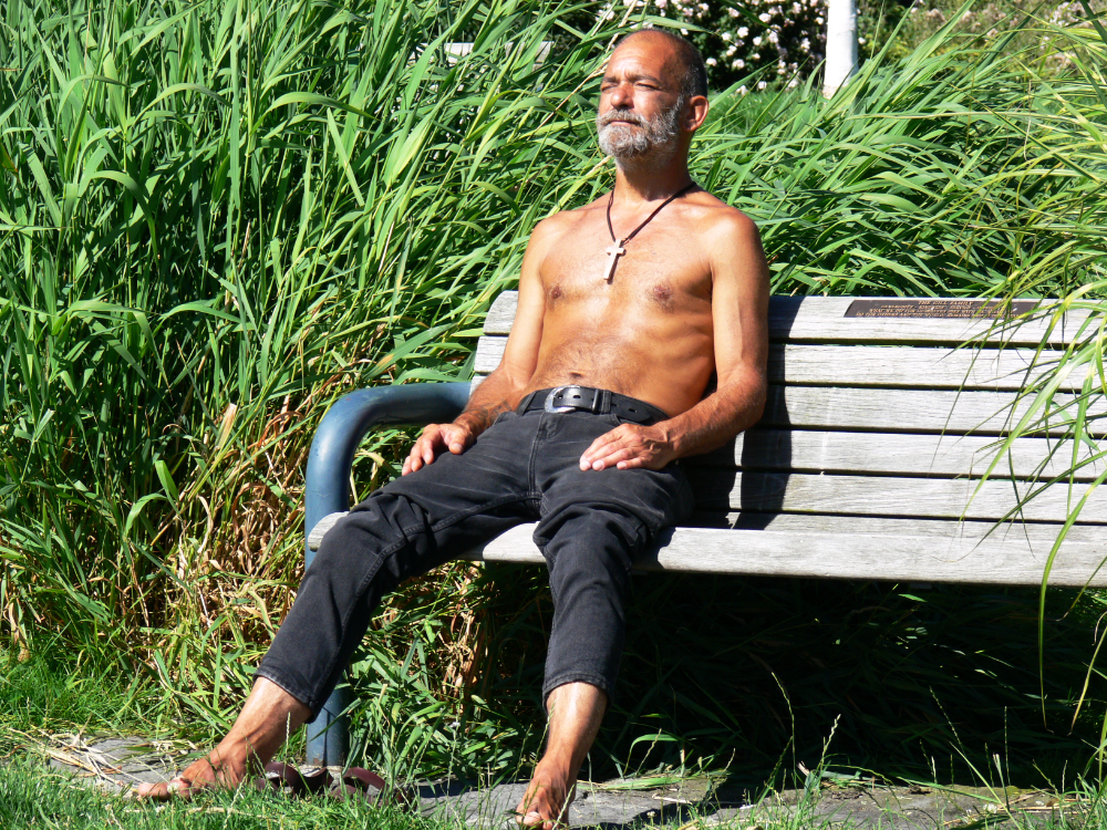 Man meditating outdoors along Vancouver's waterfront