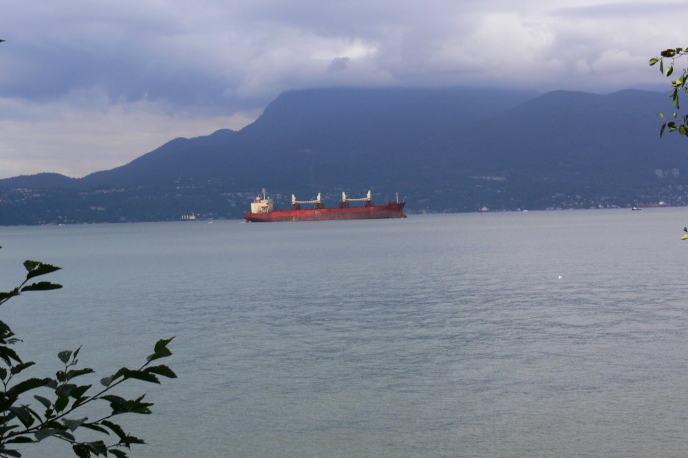 Ship entering Vancouver harbor beneath overcast skies