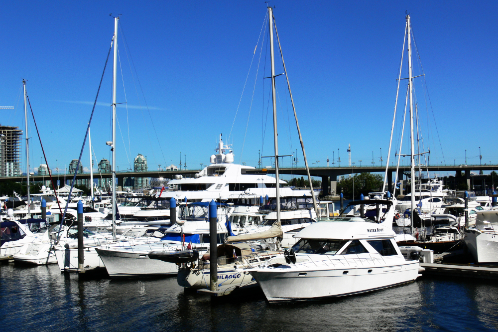 Yachts in a Vancouver marina with the city skyline behind them
