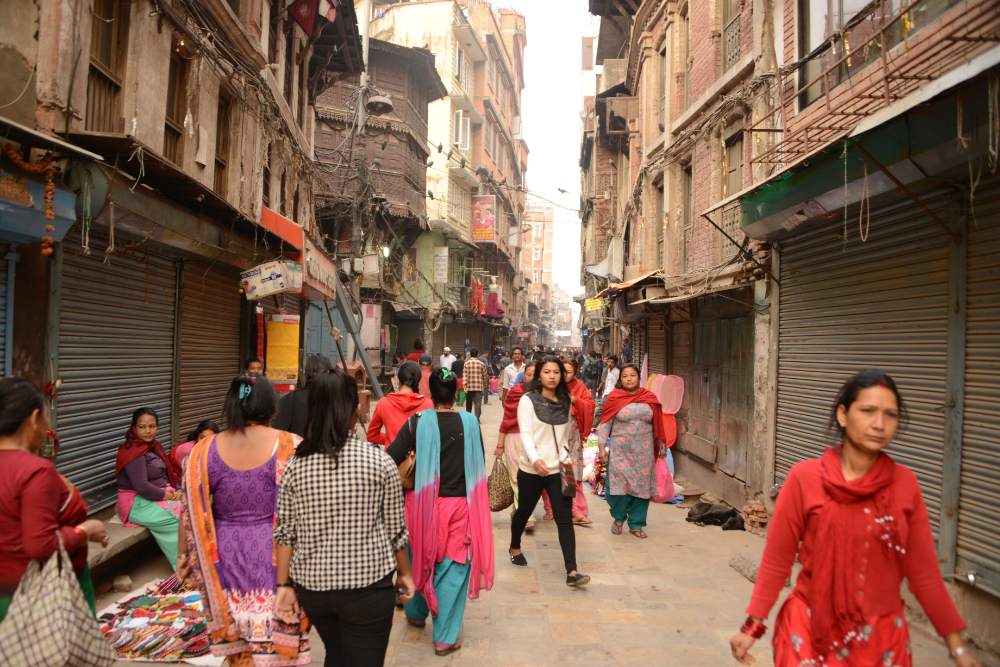 People going about daily life on a busy street in Kathmandu