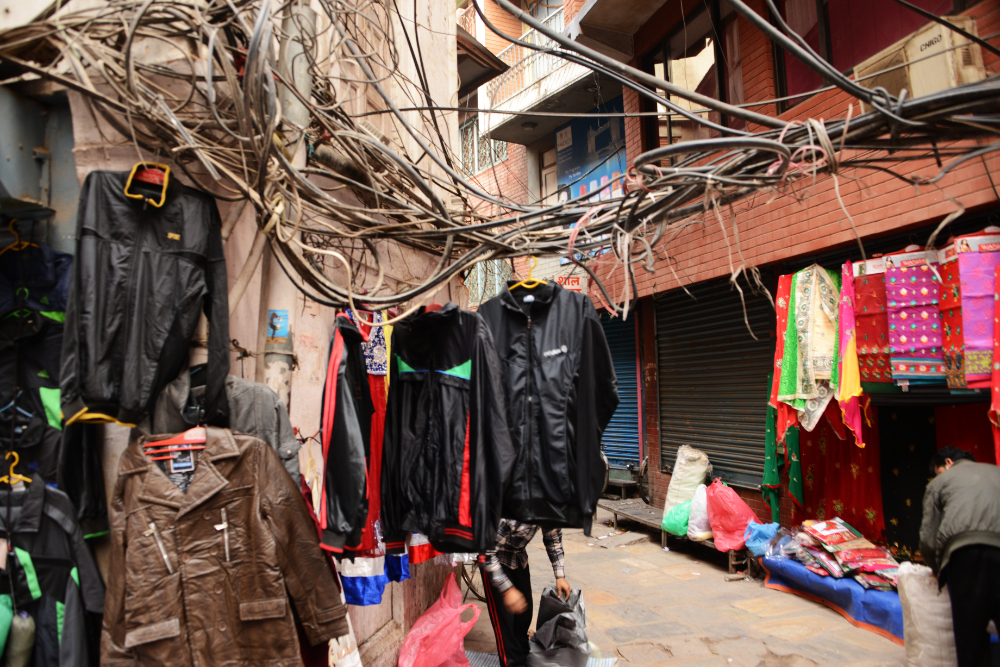 Clothing displayed for sale along a street in Kathmandu