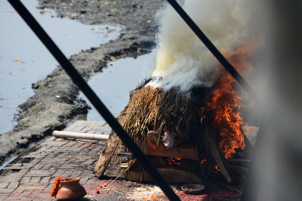 Traditional Hindu funeral pyre beside the Bagmati River at Pashupatinath Temple