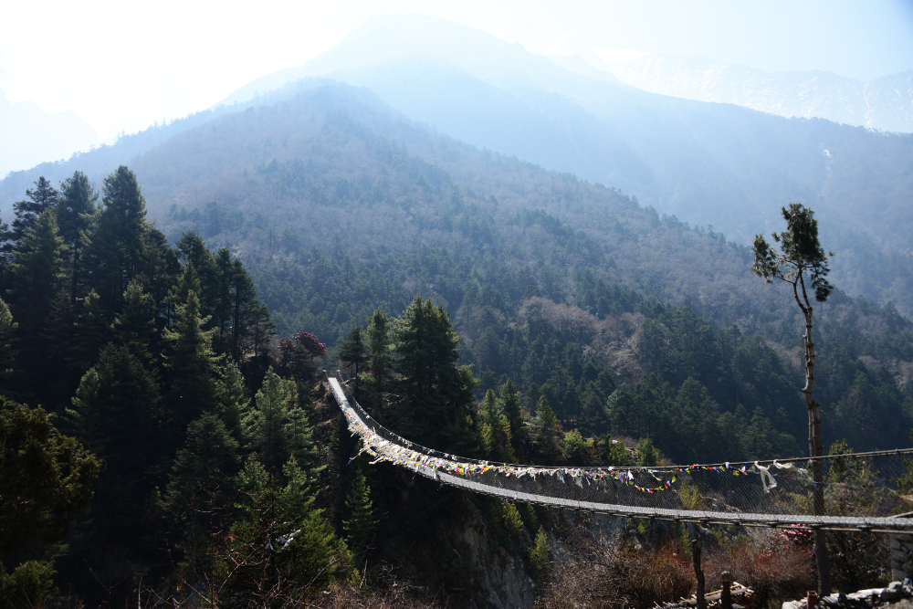 Long suspension bridge over a river on the Everest Base Camp trekking route