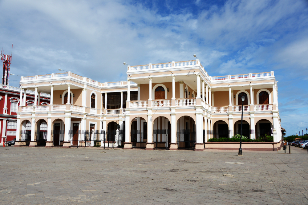 Historic colonial buildings surrounding Granada's central plaza in Nicaragua