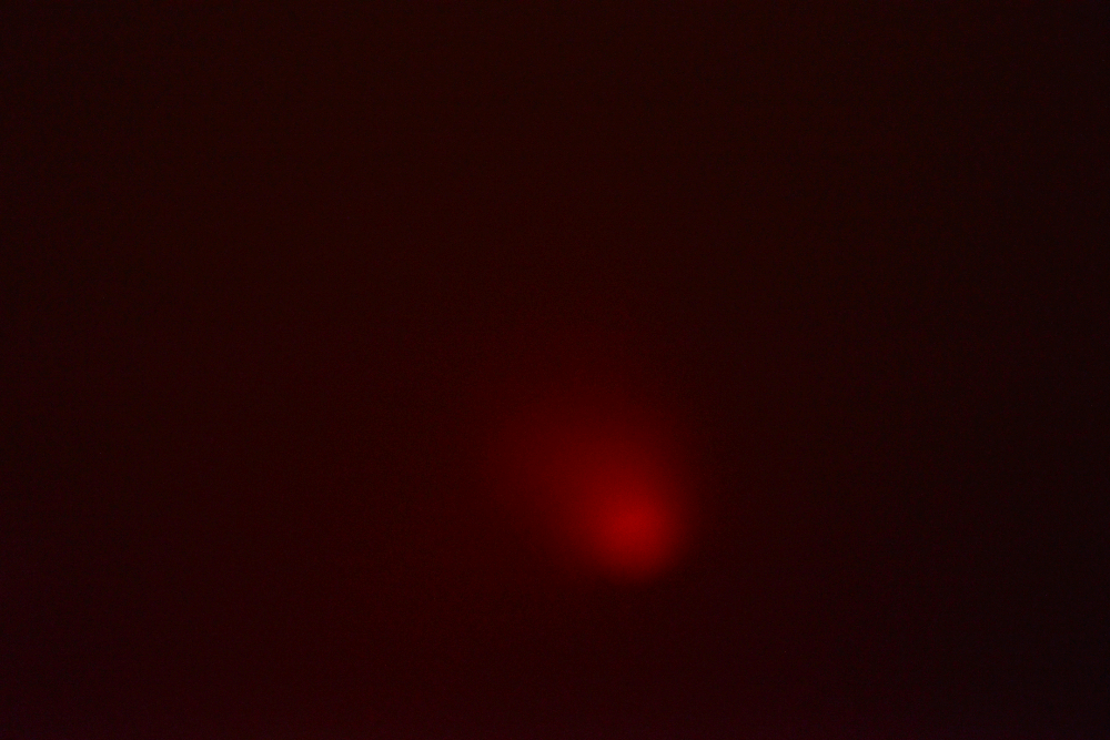 Orange glow of molten lava visible through volcanic gases inside Masaya Volcano