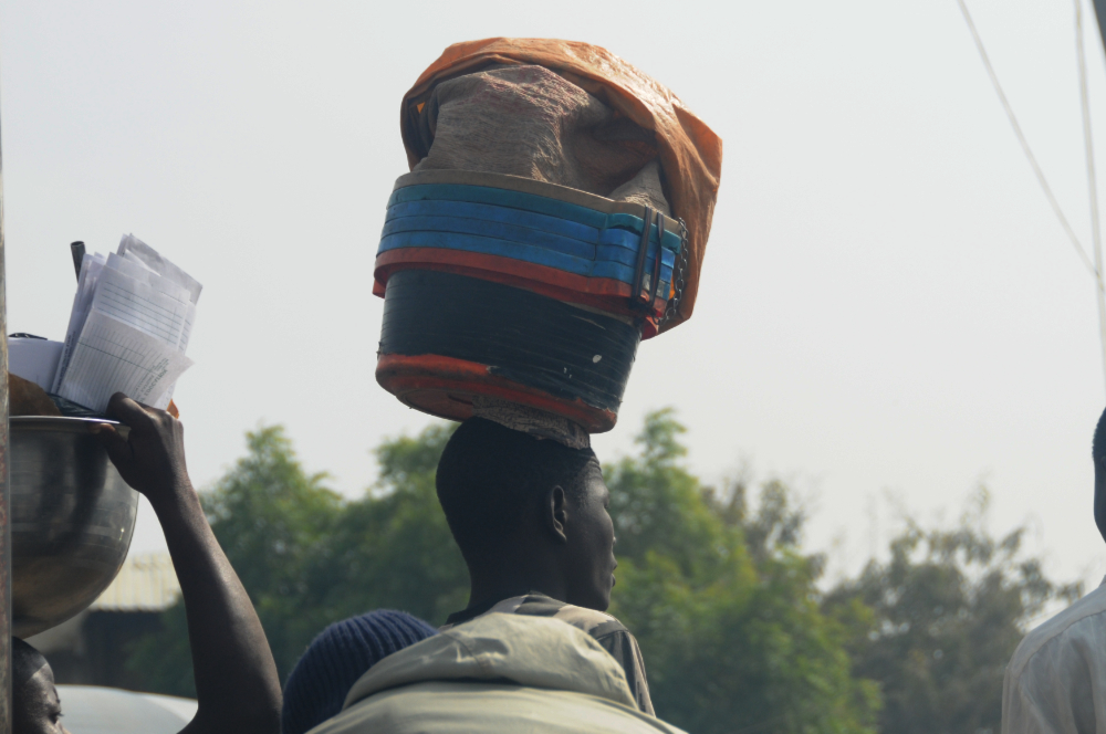 Man balancing goods on his head in Kano Nigeria