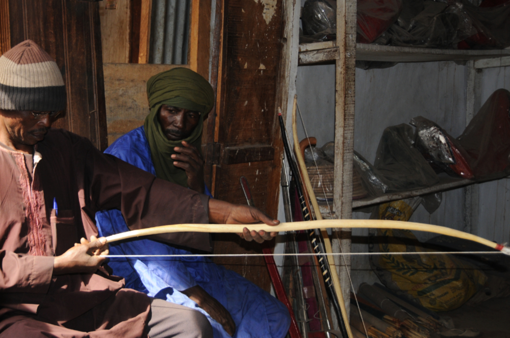 Men selling traditional bows and arrows in Kano Old City market