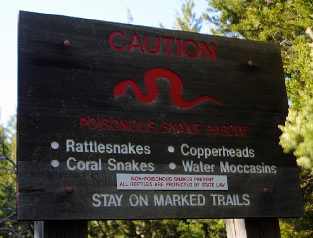 Venomous Snakes Warning Warning sign about venomous snakes along a hiking trail near Dallas Texas