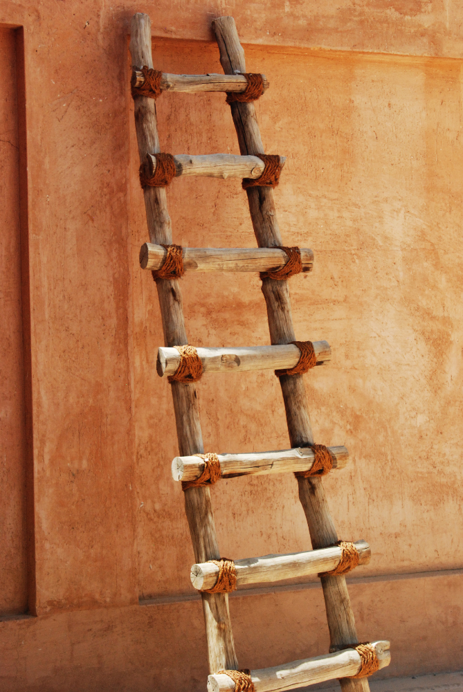 Traditional wooden ladder displayed in an Al Ain museum