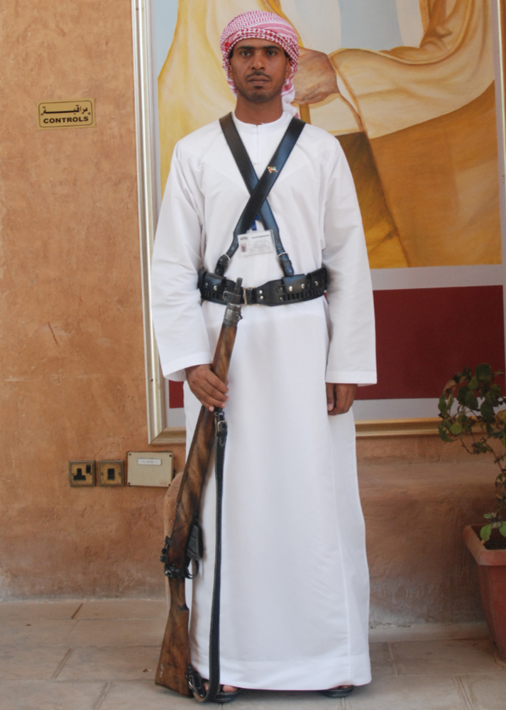 Guard standing near the entrance of a museum in Al Ain